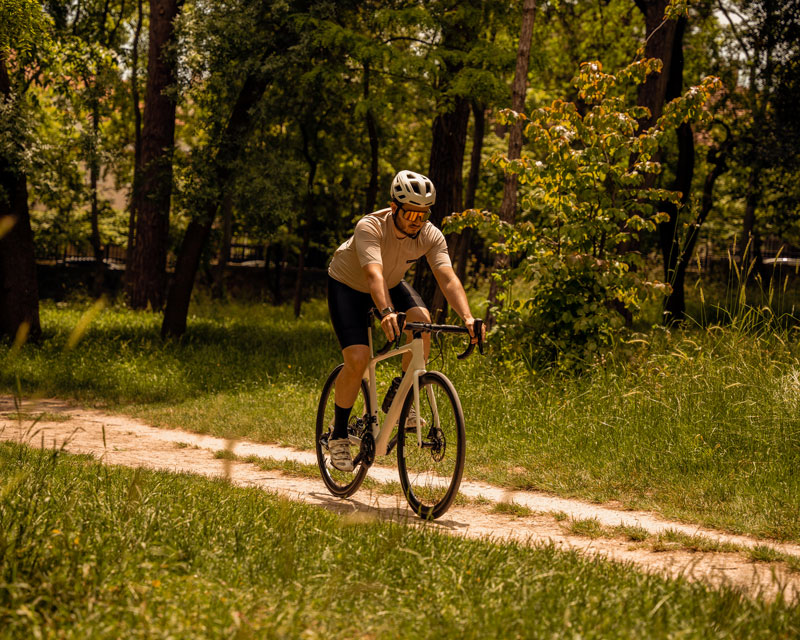 Rennradfahrer fährt auf einem Waldweg durch die Natur rund um Oranienburg